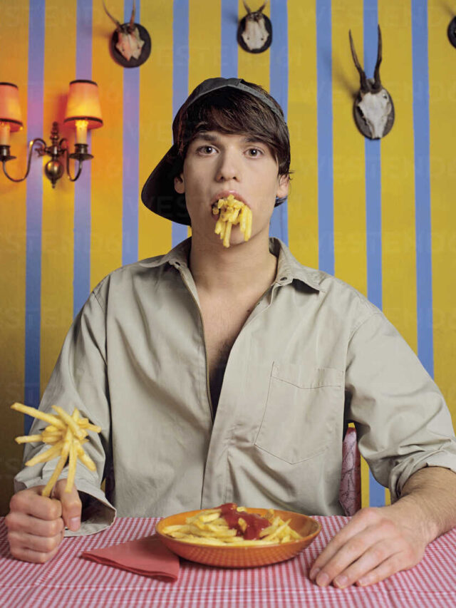 young-man-eating-french-fries-JLF00029
