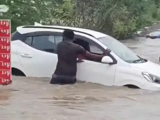 Car Swept Away In Rain Water